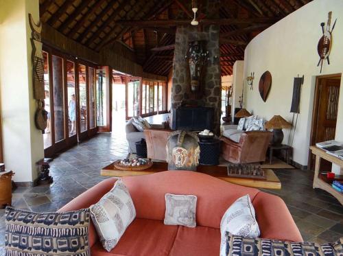 a living room with a couch and a fireplace at Metsi Lodge in Welgevonden Game Reserve