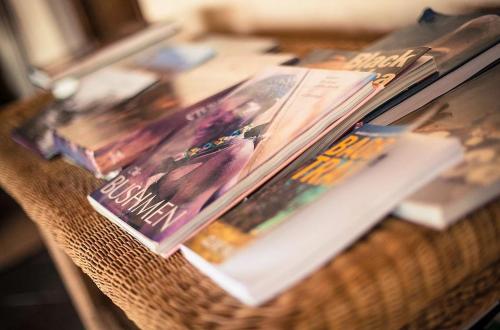 a table with magazines and books on it at Metsi Lodge in Welgevonden Game Reserve