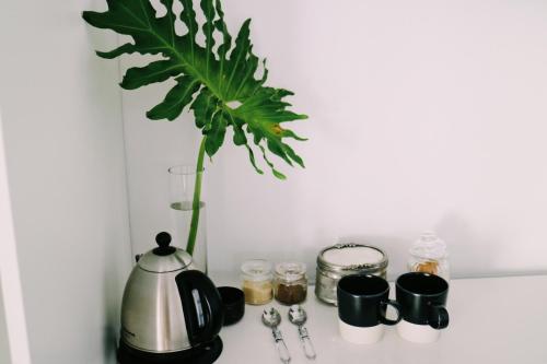 a vase with a plant sitting on top of a counter at 9 Windsor House in Tokai
