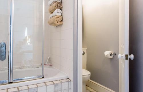 a bathroom with a shower and a toilet at Dale Street Apartments Suite in Leamington Spa