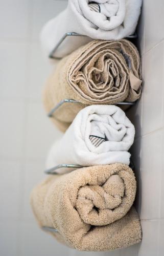 four towels in a towel rack on a wall at Dale Street Apartments Suite in Leamington Spa