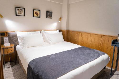 a bedroom with a large bed with white sheets and pillows at MEG HOTEL in Istanbul
