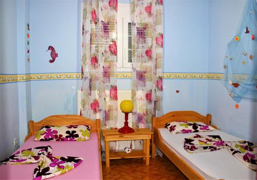 a bedroom with two beds and a window at Vanna's Holiday House in Ierissos