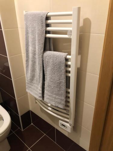 a bathroom with white towels hanging on a rack at Studio 104 in Mantes-la-Jolie