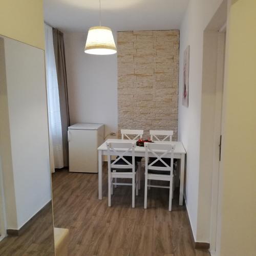 a dining room with a white table and chairs at Guest House Piatra Craiului in Bran