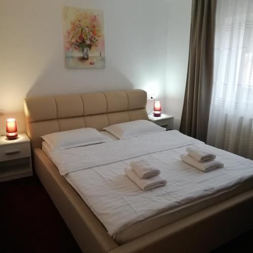 a bedroom with a bed with two towels on it at Guest House Piatra Craiului in Bran