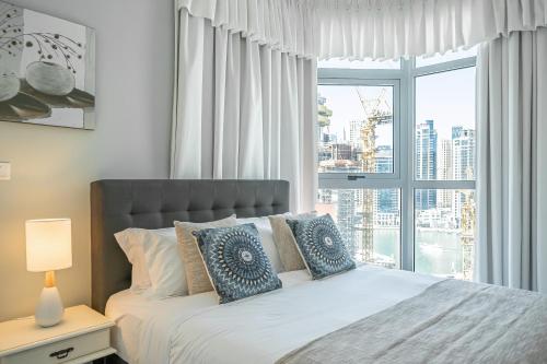 เตียงในห้องที่ Luton Vacation Homes - Marina Residence-Marina view-A12AB01