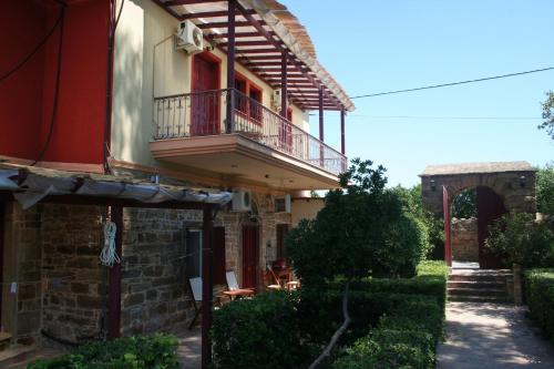 a building with a balcony on the side of it at Manganos Apartments in Kambos