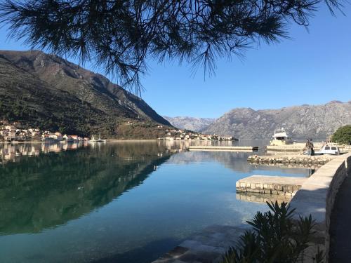 a view of a lake with mountains in the background at Villa Miramare , Dobrota seafront in Kotor