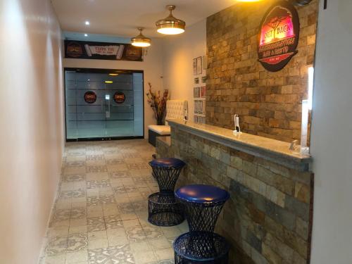 a bathroom with two stools and a counter with a sink at Out Back in Olongapo