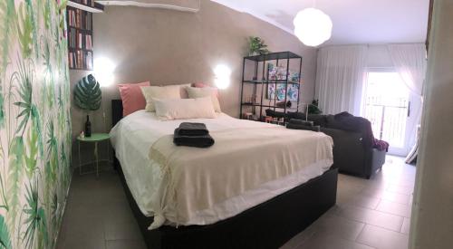 a bedroom with a large bed with a white blanket at Montserrat in Calonge