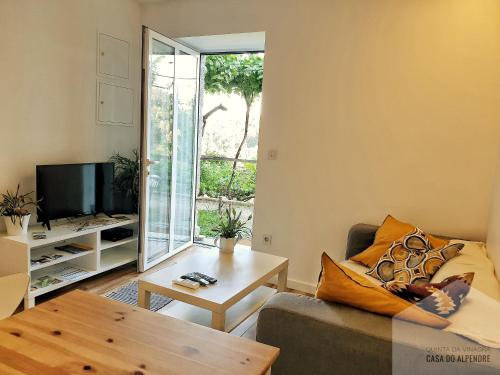 a living room with a couch and a table at Quinta da Vinagra in Tourim