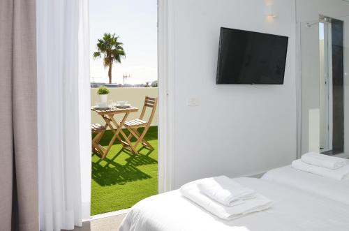 a room with two beds and a view of a patio at Canary Lofts Palace in Santa Cruz de Tenerife