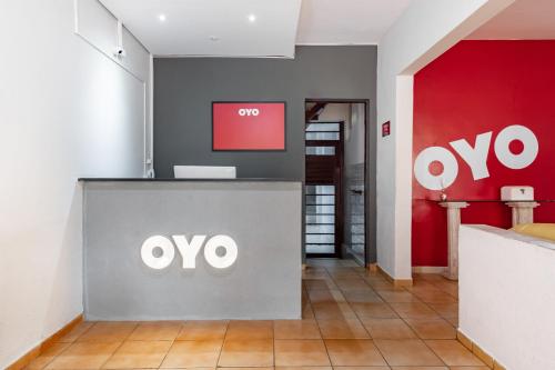 an office with an omega sign on the wall at OYO Pousada Tia Léo Campinas in Campinas