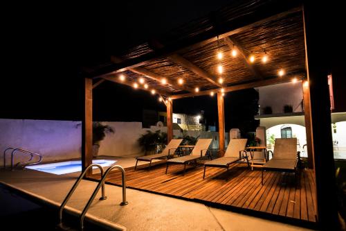 a wooden deck with chairs and lights on it at Hotel Boutique Casa Xaan in Valladolid