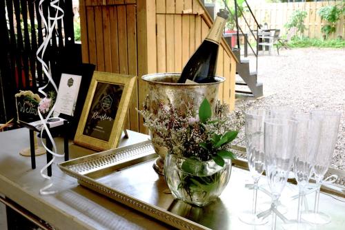 a table with a bottle of wine and glasses on it at L'Hotel Particulier Griffintown in Montréal