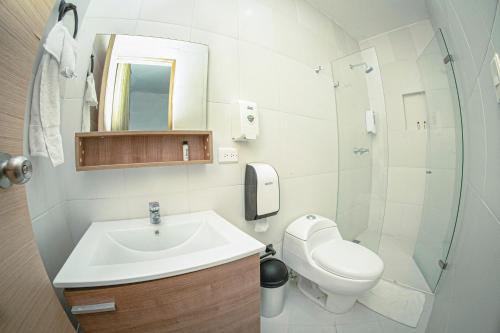 a bathroom with a sink and a toilet and a shower at Hotel Llanogrande Airport in Rionegro