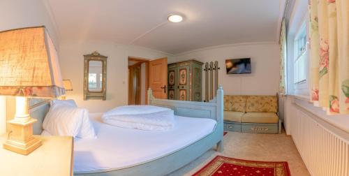 a small bedroom with a bed and a couch at Ahorn Chalet in Mayrhofen