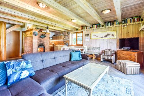 a living room with a couch and a table at Latkrantė in Latežeris