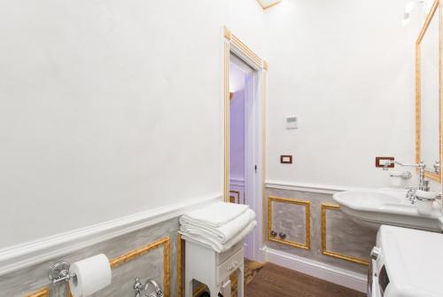 a bathroom with a sink and a mirror at THE IMPERIAL SUITE e THE BRICKS in Rome