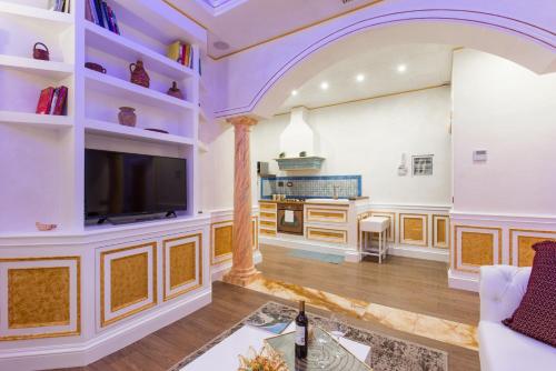a living room with a tv and a couch at THE IMPERIAL SUITE e THE BRICKS in Rome