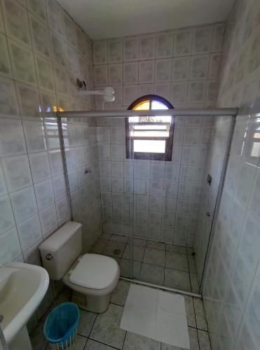 uma casa de banho com um WC e um lavatório em Oásis Pousada em Bertioga
