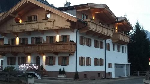 a large white building with wooden balconies on it at Apart Söllbacherhof in Fügen