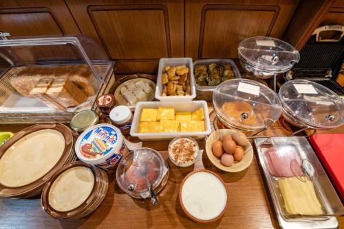 a table topped with lots of different types of food at Xenonas Kypseli in Kipseli