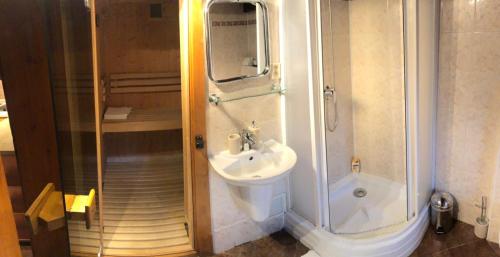 a bathroom with a sink and a shower at Chalupa Alzbeta in Liptovský Ján
