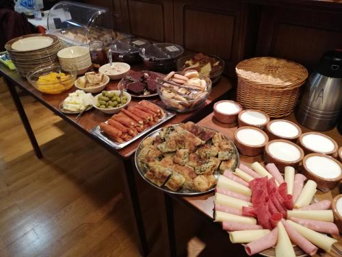 a table topped with lots of different types of food at Xenonas Kypseli in Kipseli