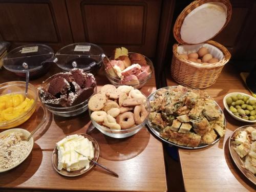 a table topped with lots of different types of food at Xenonas Kypseli in Kipseli