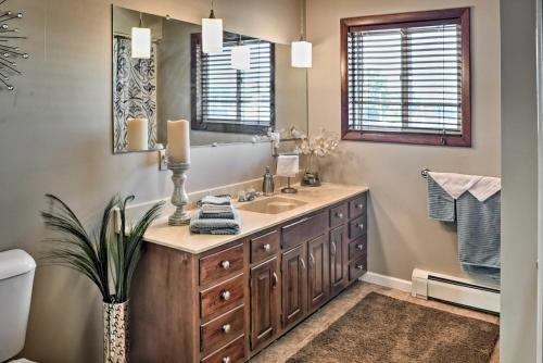 a bathroom with a sink and a mirror at East Tawas Apartment Near Lake Huron and Downtown! in East Tawas