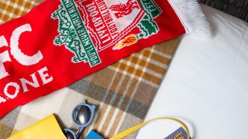 a pair of scissors and a red sweater on a table at Staybridge Suites Liverpool by IHG in Liverpool