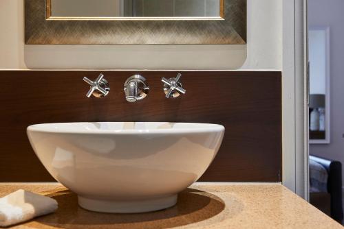 a white sink on a counter in a bathroom at Staybridge Suites Liverpool by IHG in Liverpool