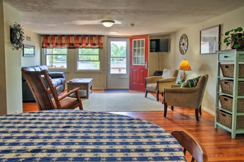 a bedroom with a bed and a living room at Lakefront Wakefield Cottage with Deck and Water Views! in Wakefield