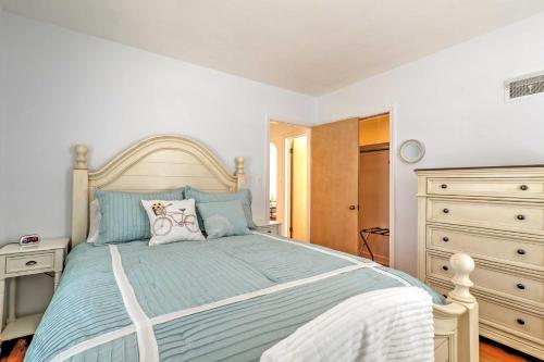 a bedroom with a bed with a blue comforter at Williams Bay Retreat Walk to Lake Geneva and Town! in Lake Geneva