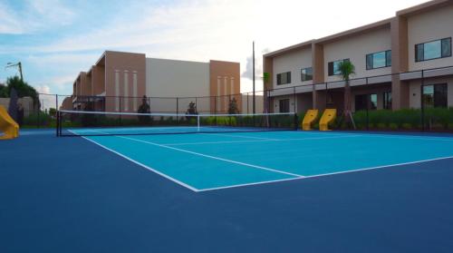 a tennis court in front of a building at Magic Village Views Trademark Collection by Wyndham in Orlando
