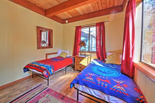 a bedroom with two beds and a window at Big Bear Cabin with Fenced Yard 4 Mi to Snow Summit in Big Bear City