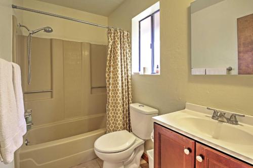 a bathroom with a toilet and a sink and a shower at Big Bear Cabin with Fenced Yard 4 Mi to Snow Summit in Big Bear City