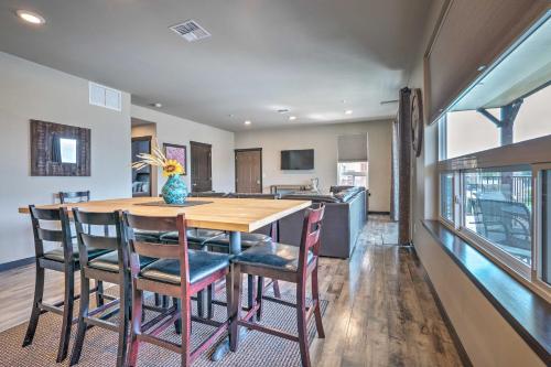 a kitchen and dining room with a wooden table and chairs at Modern Manson Condo with Pool and Lake Chelan Views! in Manson