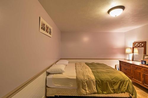 a small bedroom with a bed and a dresser at Cozy Union Pier House with Hot Tub, Deck and Backyard! in Union Pier