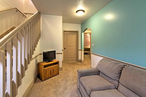 a living room with a couch and a tv at Cozy Union Pier House with Hot Tub, Deck and Backyard! in Union Pier