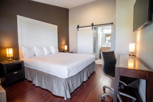 a bedroom with a large white bed and a desk and a desk at Hershey Farm Resort in Ronks