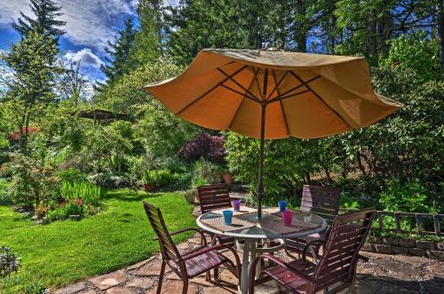 a table and chairs with an umbrella in a garden at Anns Aerie Home with Gorgeous Views and Special Rates! in Stevenson