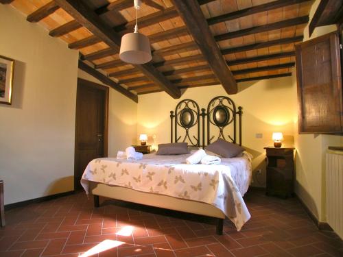 a bedroom with a large bed in a room at Serre di Parrano in Nocera Umbra