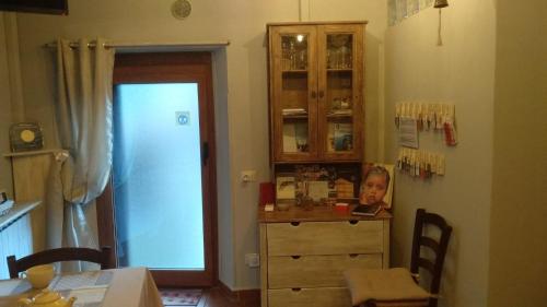 a kitchen with a table and a dresser with a picture on it at Casa Quaratica in Riccò del Golfo di Spezia
