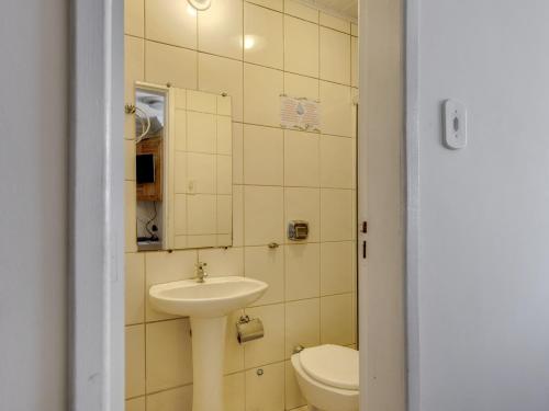 a bathroom with a sink and a toilet at Hotel Estrela Do Vale in Ipatinga