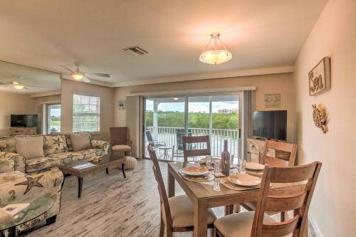 a living room with a table and a couch at Waterfront Marco Island Retreat with Shared Docks in Marco Island