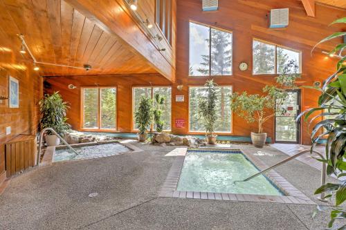 a home with a swimming pool in a room with wooden walls at Silverthorne Condo Patio, Mtn Views, Pool Access! in Silverthorne