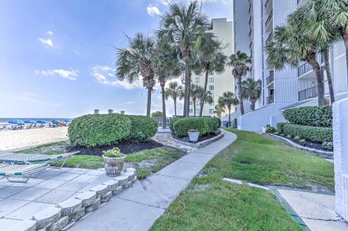 a pathway to the beach with palm trees and a building at Chic Myrtle Beach Seaside Escape with Pool Access! in Myrtle Beach